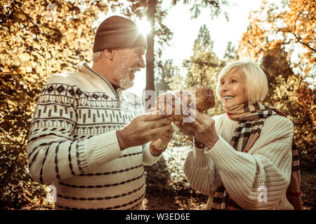 Husband and wife holding mushrooms and looking at each other. Stock Photo