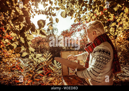 Thoughtful painter looking at the landscape in the front. Stock Photo
