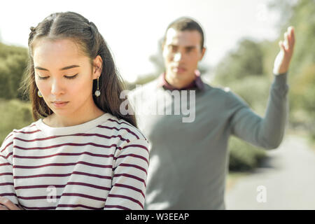 Angry man actively gesturing while arguing with girlfriend Stock Photo