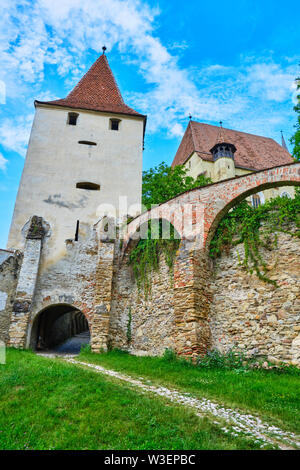 Defense tower and exterior walls of Biertan fortified church, in Transylvania, Romania. Tourism concept for scenic locations and perfect, blue sky wea Stock Photo