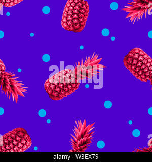 Pineapples Seamless pattern Bright pop-art pattern with many pink pineapples on a vibrant dotted blue background Stock Photo
