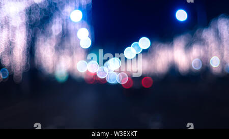 Defocused night Street lights. Bokeh street lights from cars in the city. Stock Photo