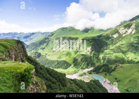 Amazing mountain landscape in Georgia on sunny summer day. Alpine green meadow in Caucasus highlands. Idyllic valley in Svaneti mountains. Stock Photo