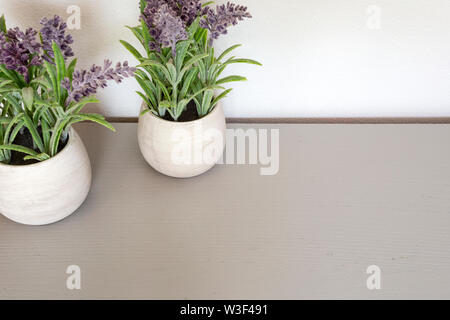 Bouquet of dry lavender in ceramic pot with white wall. Copy space for text. Stock Photo