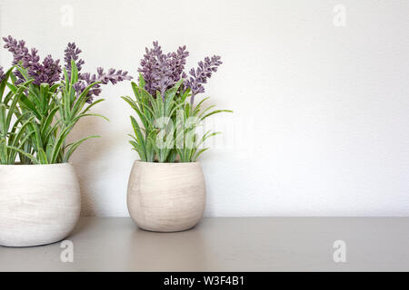 Bouquet of dry lavender in ceramic pot with white wall. Copy space for text. Stock Photo
