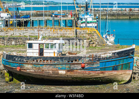 Decaying old fishing boat in the harbour at Newlyn fishing village near Penzance in Cornwall, England, UK. Stock Photo