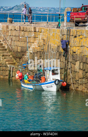 Small fishing boats in Mousehole harbour Cornwall England GB UK EU Europe Stock Photo