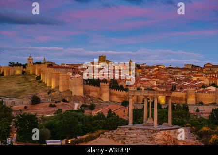 Medieval monumental walls and the four posts monument at sunset, UNESCO World Heritage Site. Avila city. Castilla León, Spain Europe Stock Photo
