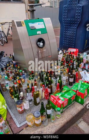 Lots of empty glass bottles in a glass container for recycling. Bordeaux, Gironde. Aquitaine region. France Europe Stock Photo