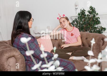 Teen girl on reception at the psychotherapist. Psychotherapy session for children. The psychologist works with the patient. Girl smiling sitting on a Stock Photo