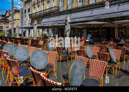 Chairs and tables on the terrace of a cafe in the historic center. Bordeaux, Gironde. Aquitaine region. France Europe Stock Photo