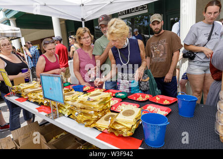 Customers enjoy samples at the annual Little Falls Cheese Festival in Herkimer County, New York, USA. Stock Photo