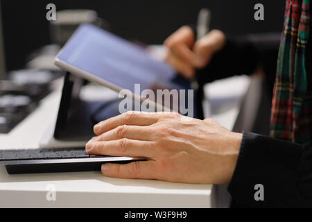 The hands of a man engaged in work with information. Stock Photo