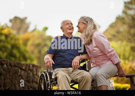 Laughing mature woman sharing a joke with her senior husband. Stock Photo