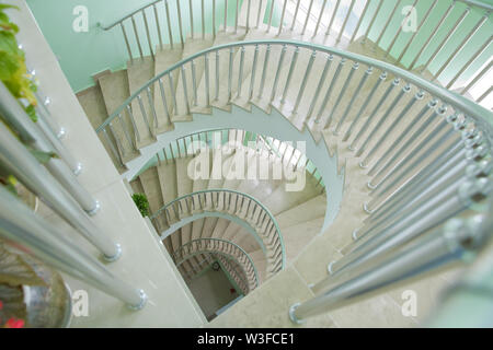 Spiraling steps . Circular Staircase. Spiral staircase from bottom view with white cement wall Spiral staircase in Lighthouse in Baku. Stock Photo