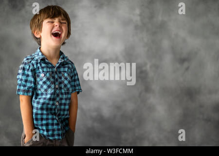 Portrait of a happy young boy laughing. Stock Photo