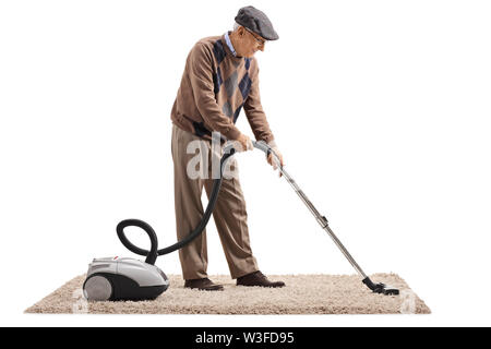 Full length shot of a senior man vacuuming a carpet isolated on white background Stock Photo