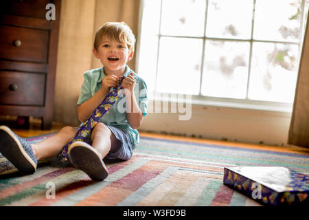 Young boy opening birthday presents. Stock Photo