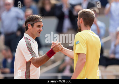 Roger Federer from Switzerland and Oscar Otte from Germany at the end of ther match during 2019 French Open in Paris, France Stock Photo