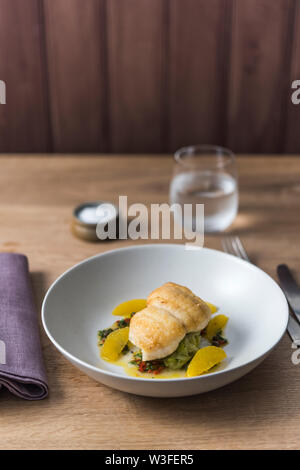 Pan fried lemon sole with capers, chilli, orange and herbs Stock Photo