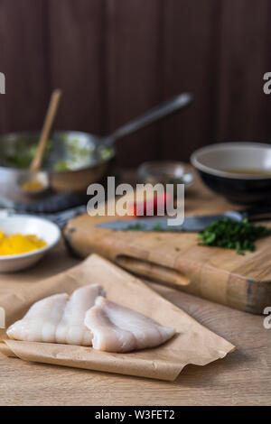 Raw Lemon sole fillets with oranges, herbs and chilli. Stock Photo