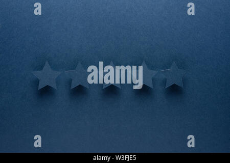 Feedback concept. Five blue paper stars of approval on a blue background Stock Photo