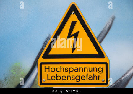 Close-up of a German high voltage caution sign mounted on a wall Stock Photo