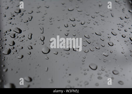 Macro/Close up of rain drops on clear window glass. Ideal for background Stock Photo