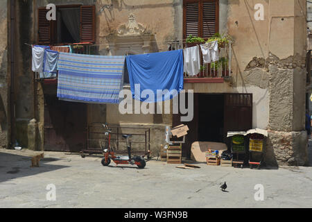 An amazing inside view of a typical day in the old town of Tropea, Italy. Bikes, peeled off buildings and hanging clothes in this Calabrian Provence. Stock Photo