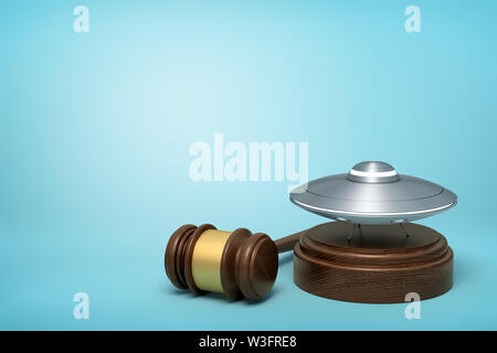 3d rendering of silver metal UFO on round wooden block and brown wooden gavel on blue background Stock Photo