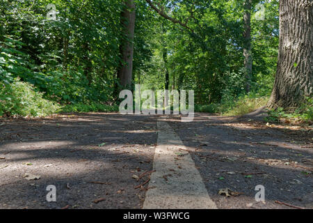 Close up of a line as a marking in the middle of a bicycle road in the nature. Muenster, Germany Stock Photo