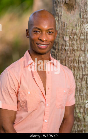 photo-of-young-handsome-man-wearing-plaid-shirt-holding-cellphone-and