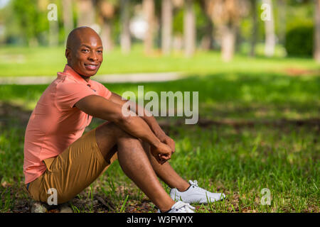 Photo of a handsome Young African American man sitting in the park. Stock Photo