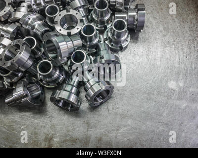 Shiny steel parts after cnc turning, drilling and machining on steel surface with selective focus. Stock Photo