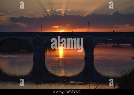 Colorful sunset in the city. The rays of light pass through the clouds. Stock Photo