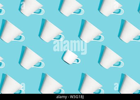 Coffee pattern of white ceramic cups for coffee on bright blue background. Stock Photo