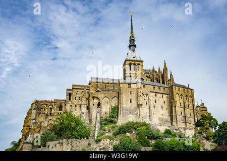Looking up to Mont Saint Michel Abbey, famous Normandy landmark, France. Stock Photo