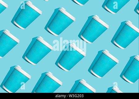 Coffee pattern of blue paper cup for coffee on bright blue background. Stock Photo