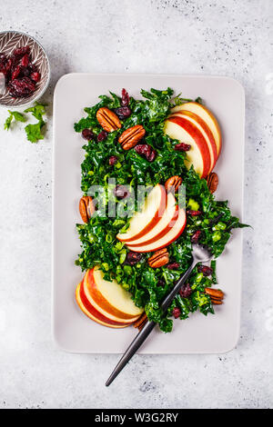 Healthy vegan salad with apple, cranberry, kale and pecan in rectangular plate. Stock Photo