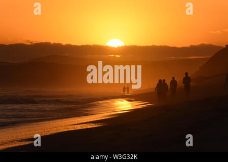 Orange Glow During Last Light On Sunset Beach Stock Photo