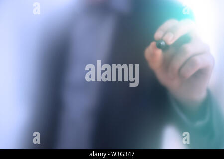Business Copy-space stock photo. Male young Businessman touching a digital screen with his electronic pen Stock Photo