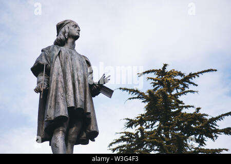Raffaello Sanzio Statue with clouds and tree in background - Urbino, Marche, Italy Stock Photo