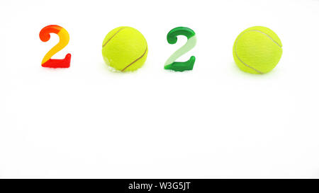 Tennis Christmas and 2020 New Year concept with tennis balls and numbers on white snow, isolated. Stock Photo