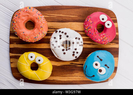 Assorted donuts on cutting board. Stock Photo
