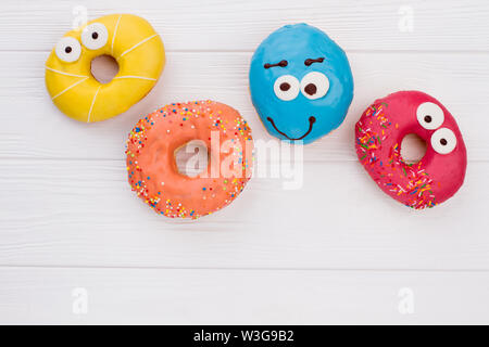 Glazed donuts on wooden background. Stock Photo