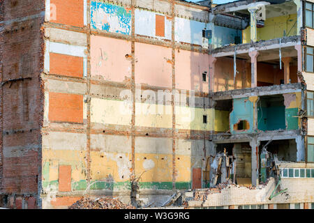 Partially destroyed industrial building with colored walls. Demolition or destruction theme Stock Photo