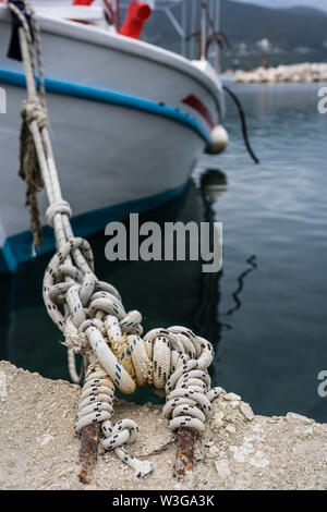 Close up of a rope holding empty fisherman boat moored in port, Zante, Greece