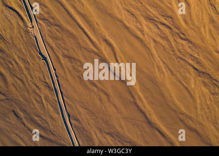 Atacama Desert vast dry extensions in the driest area of this amazing desert Just sand, rocks and car tracks remains on this old dry ground surface Stock Photo