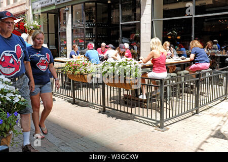 Cleveland Indians fans walk down pedestrian-only East 4th Street prior to a game in Cleveland, Ohio, USA. Stock Photo