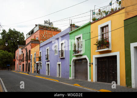Bright painted two-storey residential buildings in downtown Cholula, near Puebla, Mexico. Jun 2019 Stock Photo